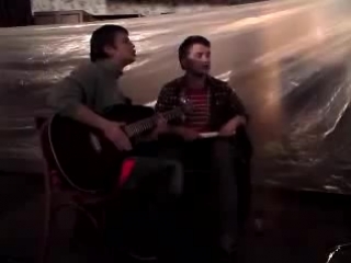 andrey shchipanov and lyosha demidov sing to the guitar